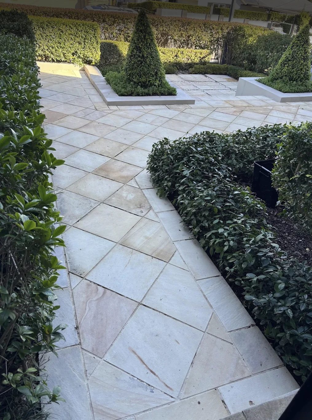 Diagonal-pattern sandstone courtyard after pressure cleaning, Sydney