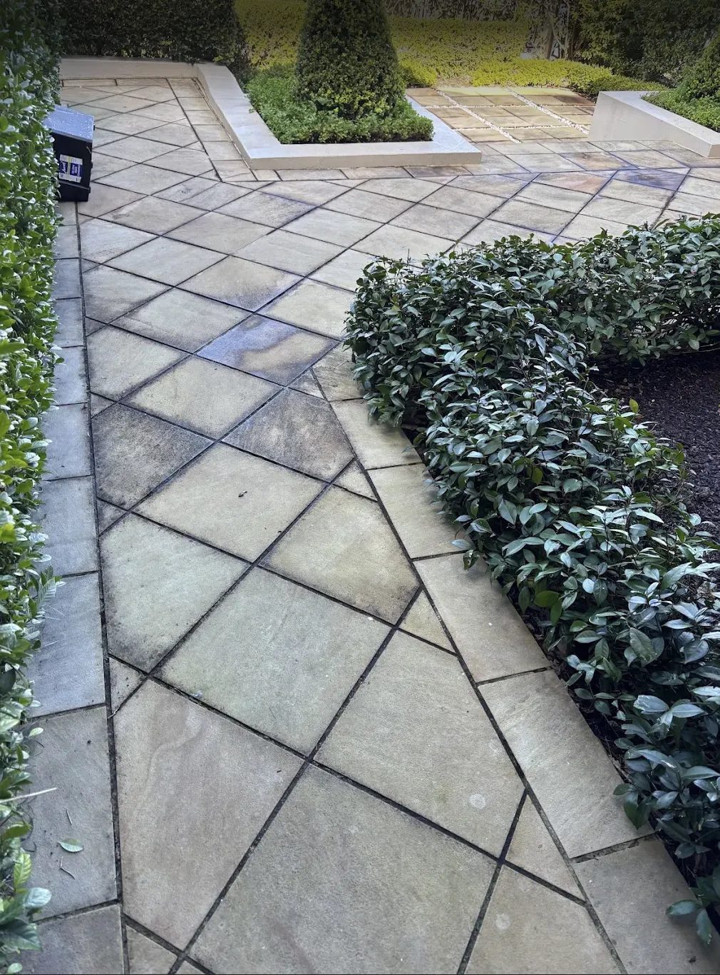 Diagonal-pattern sandstone courtyard before pressure cleaning, Sydney